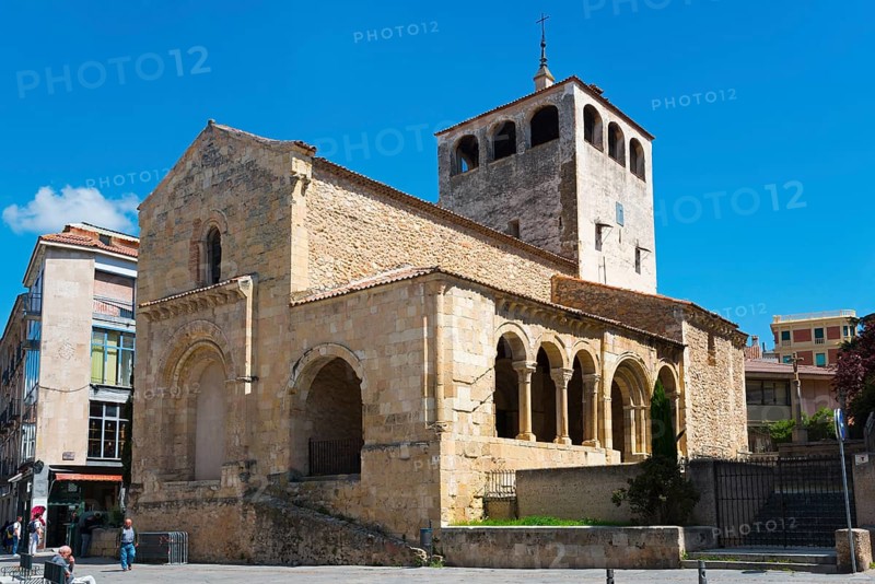Romanesque church with high tower and arches, built of stone, under a blue sky in sunny weather, San Clemente Church, Segovia, Castilla y León, Leon, Spain, Europe