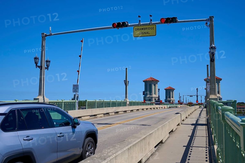 Traffic light, drawbridge and a car, with a sign, Bridge of Lions, pointing to a drawbridge, St. Augustine, Florida, USA, North America