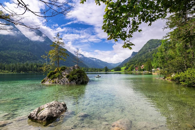 Hintersee near Ramsau with clear green water, surrounded by forests and mountains under a cloudy sky, pedal boat, Berchtesgaden National Park, Berchtesgadener Land, Upper Bavaria, Bavaria, Germany, Europe