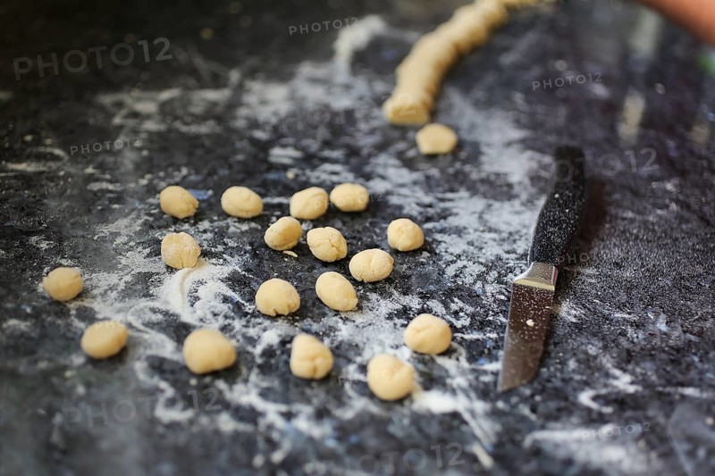 Swabian cuisine, preparation of broad beans with yeast dumplings, worktop with raw yeast balls, kitchen knife, flour, savoury, salty, typical Swabian, home cooking, traditional cuisine, plate, food photography, studio, Germany, Europe