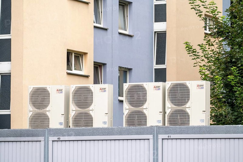 Heat pumps in a residential area, multi-family houses are supplied with heating, cooling and domestic hot water via these devices, installed on garage roofs, modernisation of the flats, Duisburg, North Rhine-Westphalia, Germany, Europe