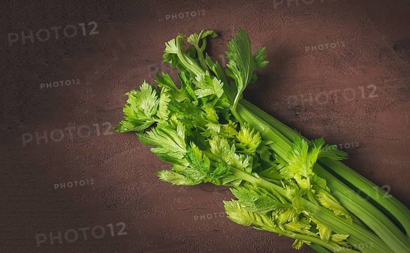 Fresh bunch of celery, top view, no people, on a dark background