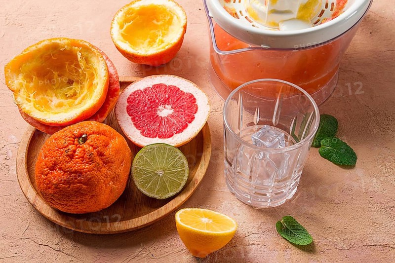 Citrus juicer, sliced fruit, glass with ice, close-up, no people, breakfast