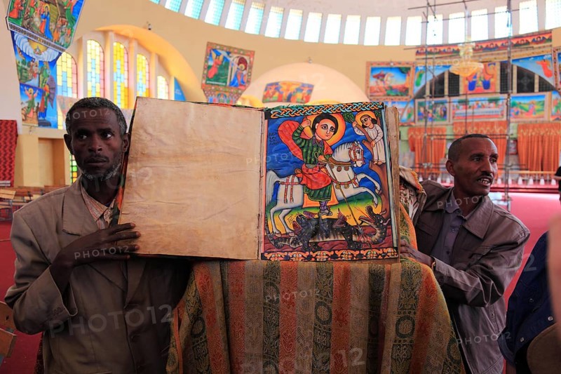 Tigray region, Axum, Aksum, St Mary's Cathedral, Maryam Tsion, inside, church servant shows old bible of the cathedral, Ethiopia, Africa