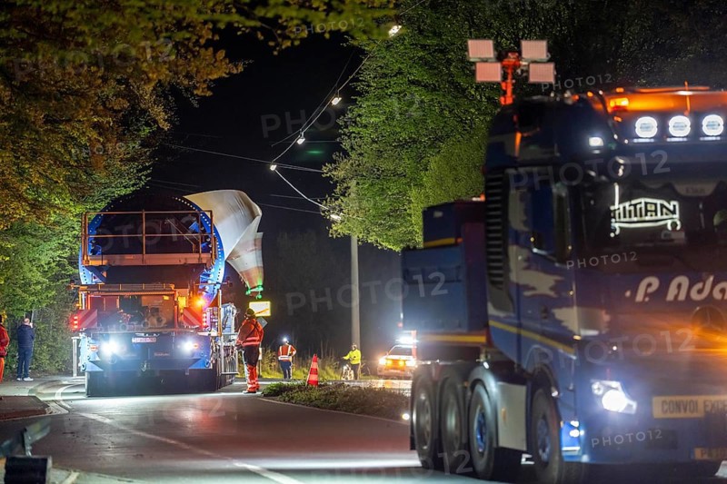 Transport of a 68 metre long, 22 tonne blade of a wind turbine, here in Schwelm, with a self-propelled Blade-Lifter vehicle, over a 40 km long route, over 2 nights, in the Bergisches Land, through towns, villages, over country roads, narrow through roads, to the construction site of the wind turbine near Hagen, North Rhine-Westphalia, Germany, Europe