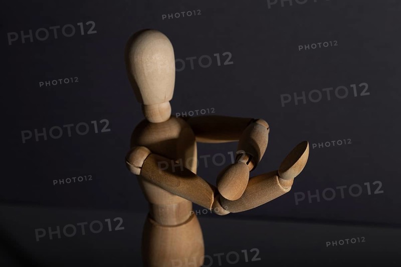 Wooden mannequin shows obscene gesture fuck off with hands on gray background. protest, riot, agression, contempt concept. copy space, hard light