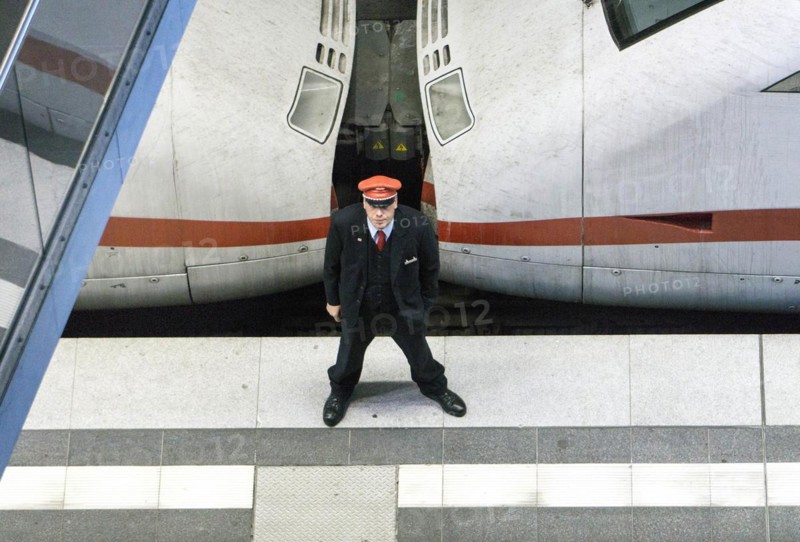 A Deutsche Bahn service employee stands in front of an ICE train on the platform at Berlin Central Station, 26 September 2016