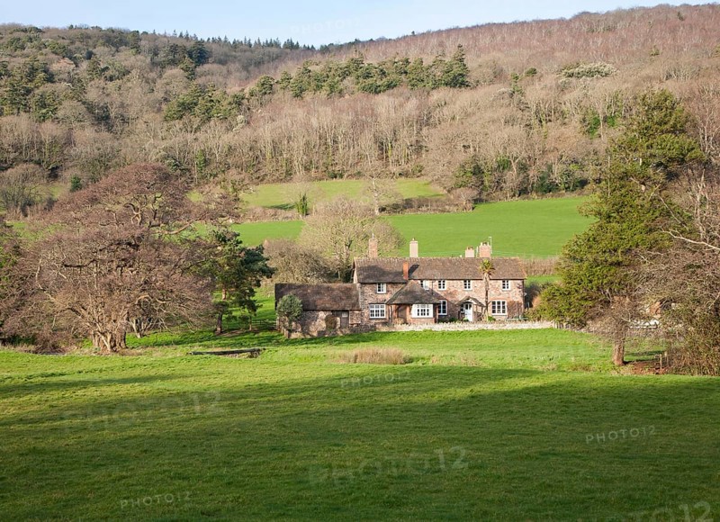 Exmoor farmhouse set amongst trees Brandish Street hamlet, Selworthy, Somerset, England, United Kingdom, Europe