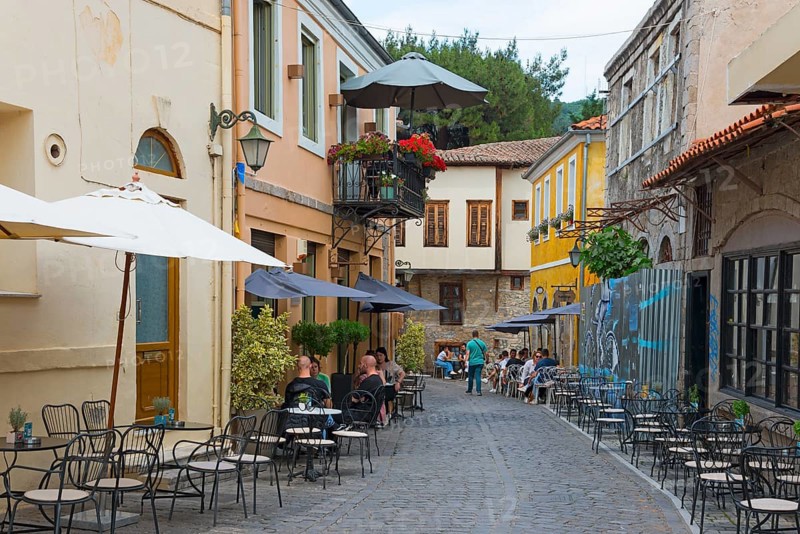 Cosy street café with guests and parasols on an old cobbled street, Xanthi, Eastern Macedonia and Thrace, Greece, Europe