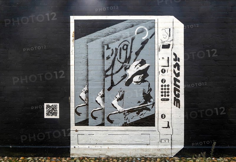 Artwork painted on wall 'Banksy art vending machine' by Joe Thompson, Lowestoft, Suffolk, England, UK