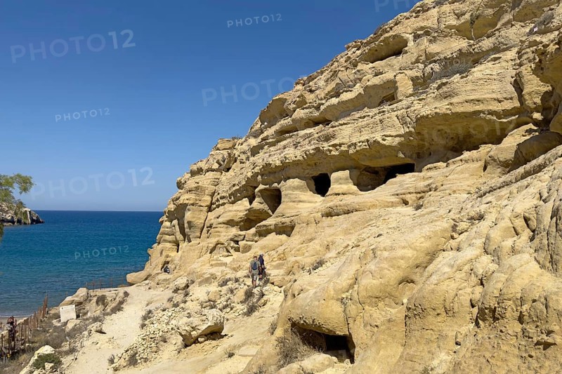 Partial view of former Roman necropolis with cave dwelling tombs carved in sandstone Grottoes in rocks on the north side of Matala Bay, in the 60s and 70s hippie caves Caves for dropouts and hippies today excursion destination on the south coast of Crete, left at the edge of the picture Libyan Sea Mediterranean, Matala, Crete, Greece, Europe