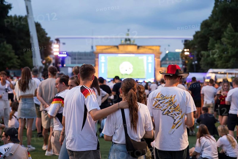 Fassball fans celebrate and gather information in the fan zone at the Brandenburg Tor after the interruption of the round of 16 match between Germany and Denmark due to a thunderstorm over the stadium in Dortmund, Berlin, 29 June 2024