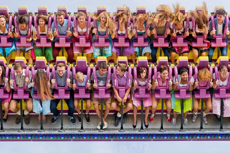 Boys and girls swinging with blowing hair in giant swing Top Spin Fresh, swing, ride on the Wies'n, Oktoberfest, Wiesn, Munich, Upper Bavaria, Bavaria, Germany, Europe