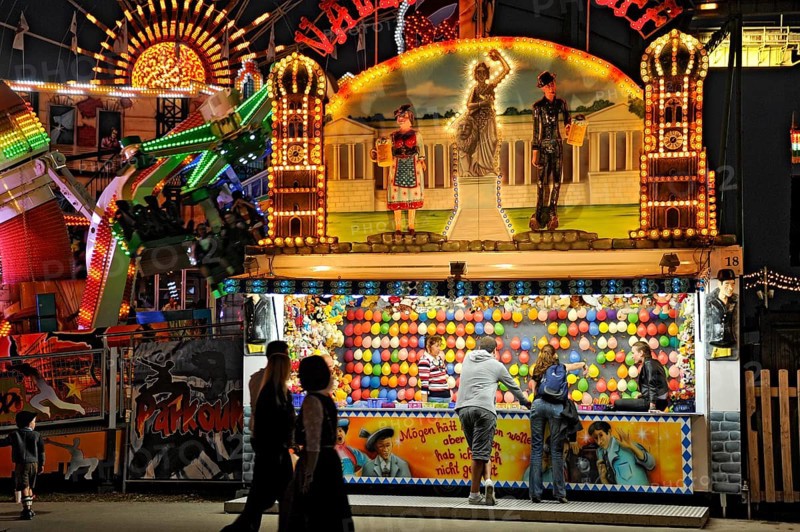 Illuminated shooting gallery, shooting gallery with balloons at night, Oktoberfest, Wies'n, Wiesn, Munich, Upper Bavaria, Bavaria, Germany, Europe