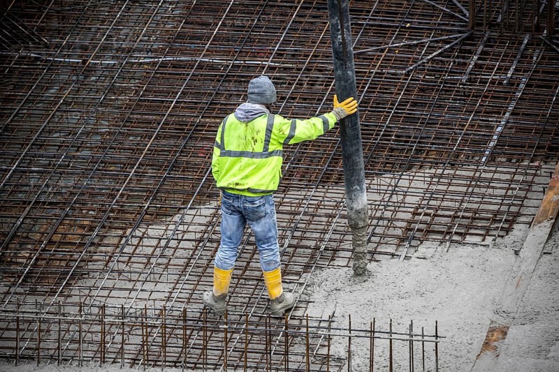 Construction site, concreting, the foundation of a building is concreted, the concrete is pumped onto the reinforced concrete mats