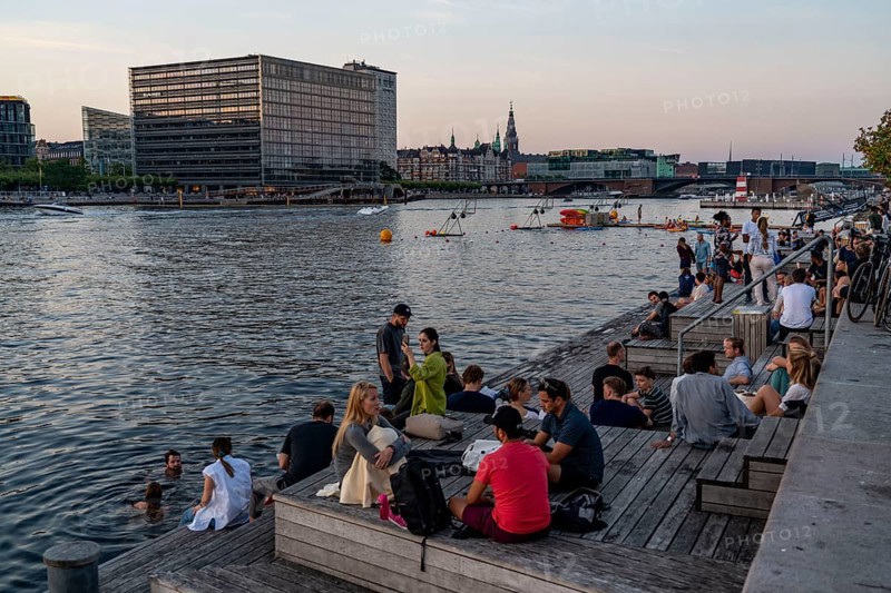 Summer evening in Copenhagen, at the harbour, Islands Brygge, people celebrating, eating, drinking, relaxing at the harbour shore, Denmark, Europe