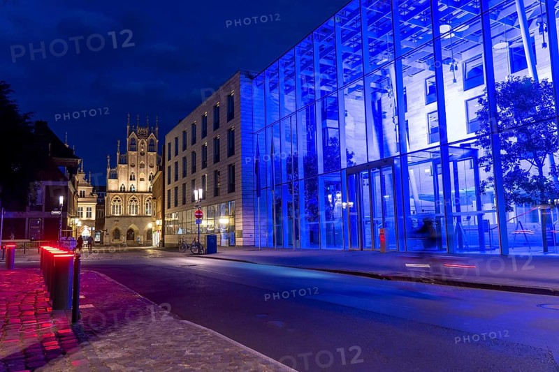 Historic old town, facade of the historic town hall, blue illuminated building of the Münster district government, illuminated barrier, bollards, in Münster, North Rhine-Westphalia, Germany, Europe
