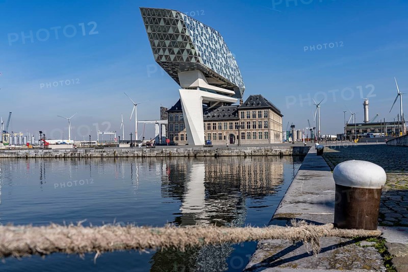 The Antwerp Port Authority building, Havenhuis, former fire brigade barracks in the harbour, renovated and with an attached glass structure in the shape of a ship's hull, administrative headquarters of the Antwerp Port Authority, designed by Zaha Hadid, Antwerp, Flanders, Belgium, Europe
