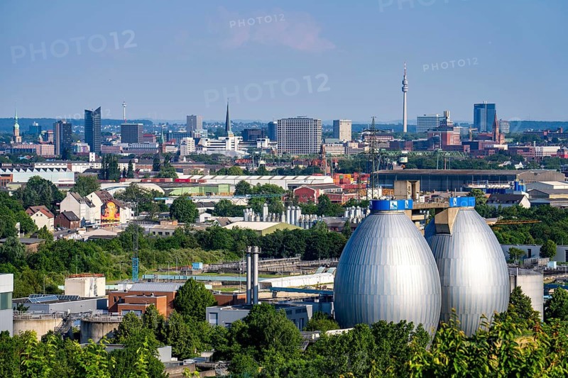View of Dortmund city centre from the Deusenberg spoil tip, with the digestion towers of the Deusen Emscher sewage treatment plant in the foreground, North Rhine-Westphalia, Germany, Europe