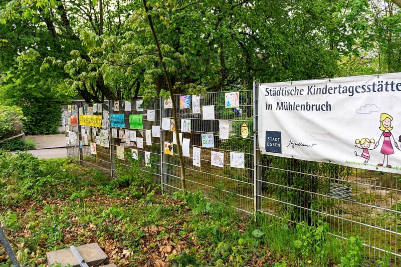 Closed municipal daycare centre Am Mühlenbruch in Essen, teachers have hung self-painted pictures of the children on a fence of the daycare centre with the slogan We miss you, effects of the corona crisis in Germany