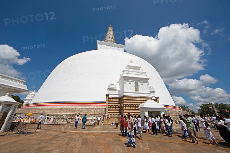 Sri Lankan pilgrims at the white stupa in the holy city of Anuradhapura, North Central Province, Sri Lanka, Asia