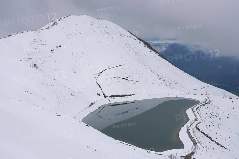 Onset of winter in May, Riezler Alpsee, an artificial lake, snow pond, feeds the snow cannons that provide the slopes of the Fellhorn and Kanzelwand cable cars with snow, Allgäu Alps, Vorarlberg, Austria, Europe