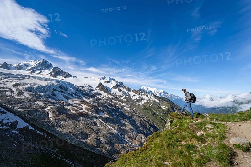 Mountaineer on a hiking trail, view of high alpine mountain landscape, summit of Aiguille de Chardonnet and Glacier du Tour, glacier and mountain peak, Chamonix, Haute-Savoie, France, Europe