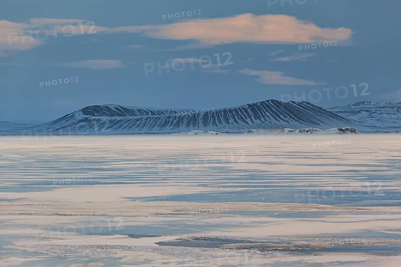 Frozen lake in a snowstorm, behind it Hverfjall crater, volcano, Myvatn, Iceland, Europe