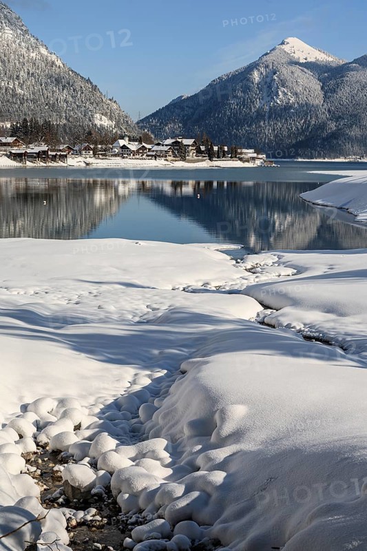 Mountains reflected in lake, village, houses, winter, snow, sunny, Walchensee, behind Jochberg, Bavaria, Germany, Europe