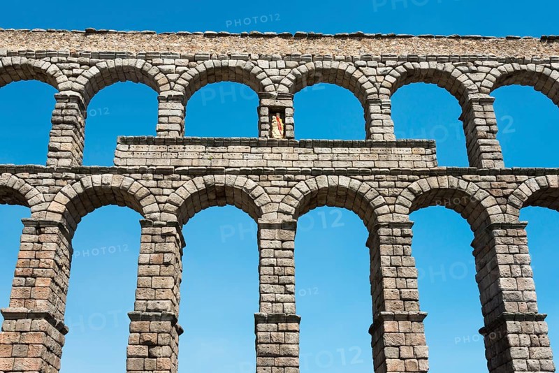 Ancient stone aqueduct with several arches in front of a blue sky, Aqueduct, Segovia, Castilla y León, Leon, Spain, Europe