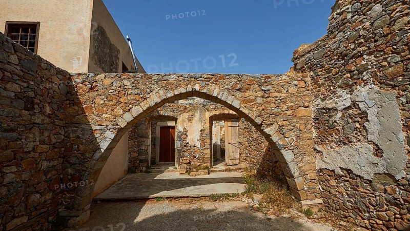 A building with stone arches and ancient walls illuminated by daylight, Venetian Sea Fortress, Leper Island, Spinalonga, Elounda Bay, Mirabello Bay, East Crete, Crete, Greek Islands, Greece, Europe