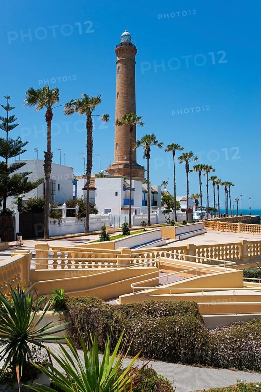 Promenade with palm trees and lighthouse on a sunny day, Faro de Chipiona, Chipiona, Cádiz province, Cadiz, Andalusia, Spain, Europe