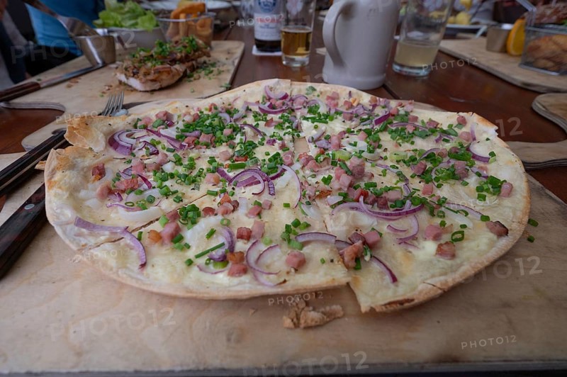 Alsatian-style tarte flambée with bacon and onions, served in a beer garden, Franconia, Bavaria, Germany, Europe
