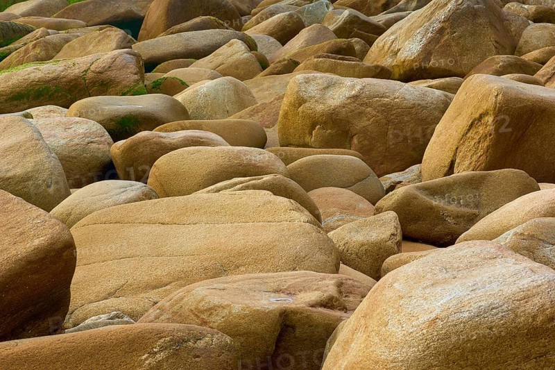 Rocky beach with beige stones in different sizes, natural texture and calm atmosphere, Quiberon, Brittany