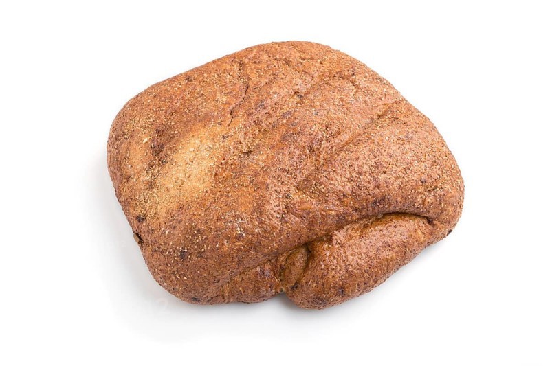 Fresh yeast free homemade bread with bran isolated on white background. side view, close up