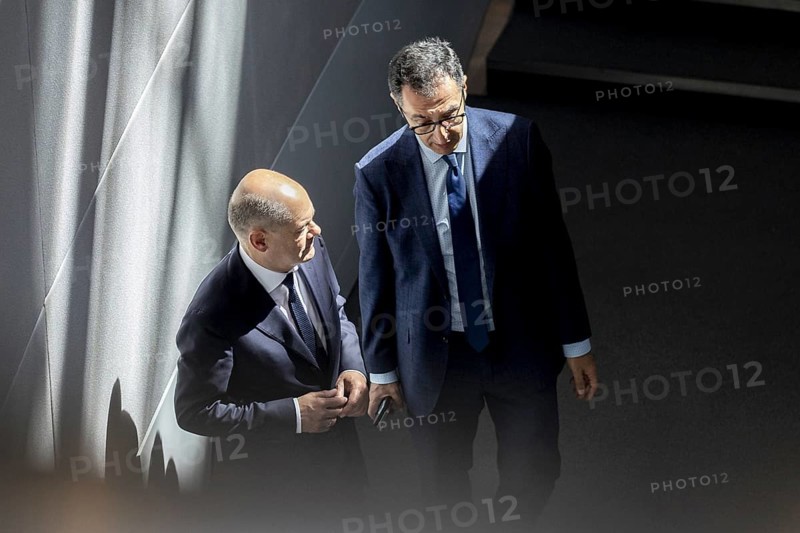 Olaf Scholz (SPD), Federal Chancellor, talks to Cem Özdemir (Alliance 90/The Greens), Federal Minister of Agriculture and Food, during the session of the German Bundestag in Berlin, 26 June 2024