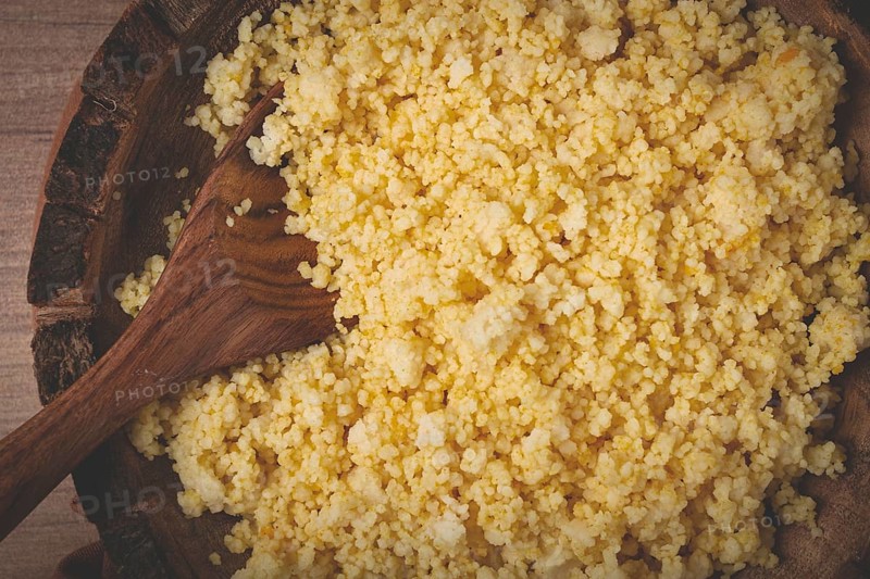 Cooked couscous, in a wooden bowl, top view, no people