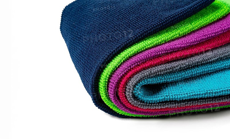 A stack of multicolored, microfiber cloths, for cleaning