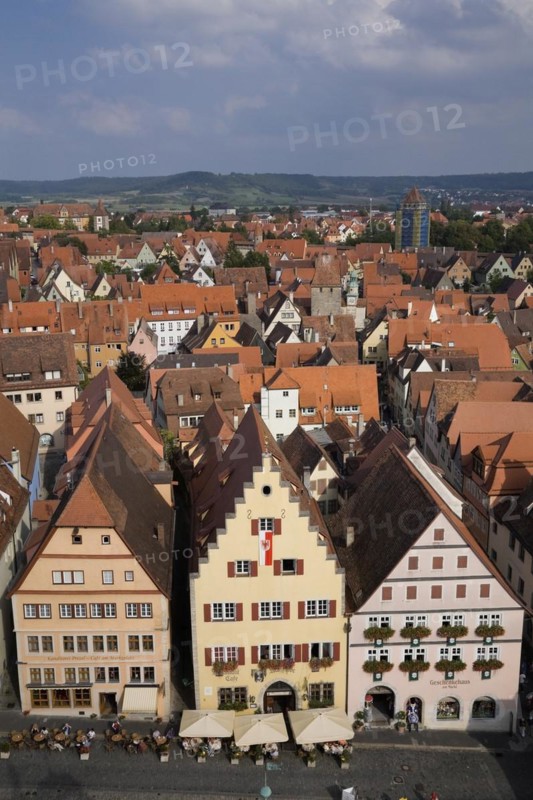 High angle view of commercial and residential buildings with traditional terracotta ceramic tiled roofs in the Market Square of the medeival town of Rothenburg in late summer, Germany, Europe