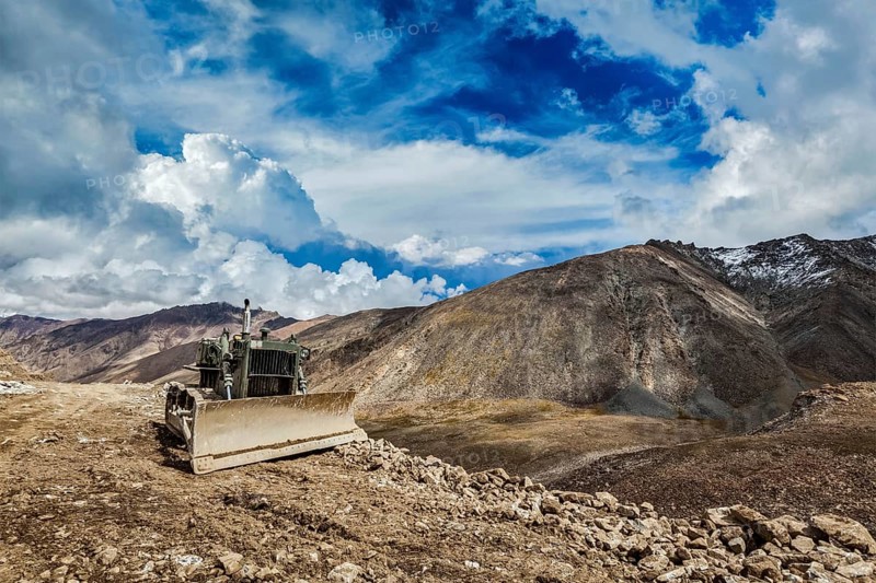 Bulldozer on road in Himalayas. Ladakh, Jammu and Kashmir, India, Asia