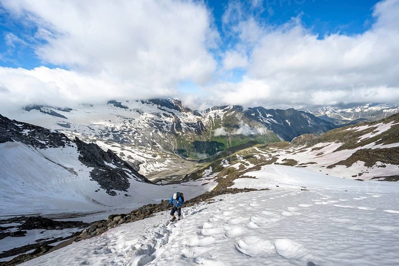 Mountaineer on hiking trail with snow, mountain landscape with summit Hoher Weißzint and Hochsteller with glacier Schlegeiskees, Berliner Höhenweg, Zillertal Alps, Tyrol, Austria, Europe