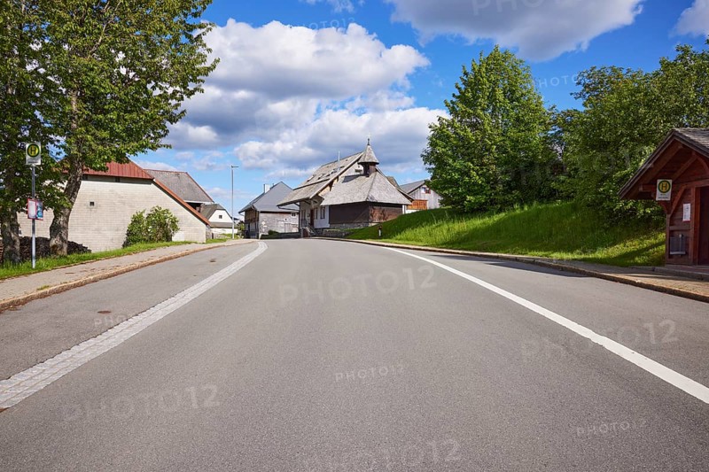Bus stop Bernau Unterlehen, road and the chapel Unterlehen under a blue sky with cumulus clouds in Bernau im Black Forest, Black Forest, Waldshut district, Baden-Württemberg, Germany, Europe