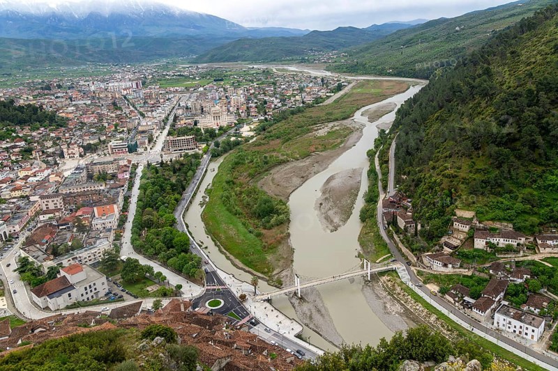 View looking over city centre of Berat in valley of River Osum with mountains beyond, Berat, Albania, Europe
