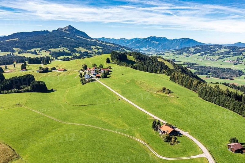 Aerial view of rural road in meadows, ridge Elleghöhe near Wertach, mountain Grünten in the back, Allgäu, Germany, Europe