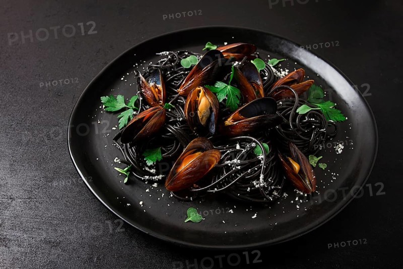 Spaghetti with black squid, black pasta, with boiled mussels, on a black plate, with parsley and parmesan cheese, close-up, selective focus, no people