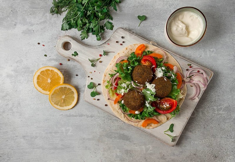 Tortilla with falafel and vegetable salad, white sauce, Arabic cuisine, top view, homemade, no people, vegetarian food