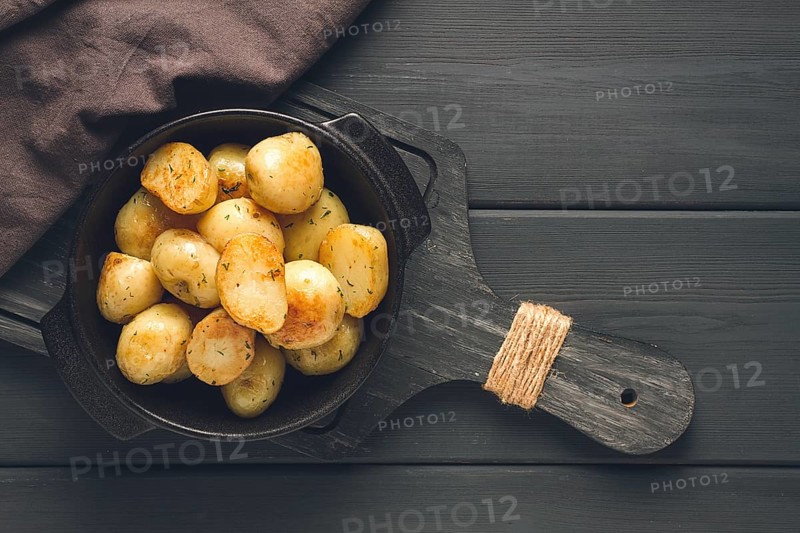 Fresh Cooked, new potatoes, with dill, on a wooden table, selective focus. close-up, toning, no people