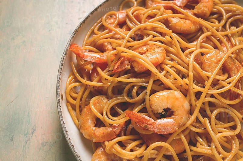 Spaghetti with king shrimps, with spices, top view, selective focus, homemade, no people