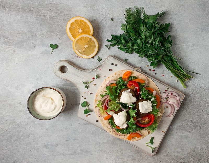 Tortilla with falafel and vegetable salad, white sauce, Arabic cuisine, top view, homemade, no people, vegetarian food