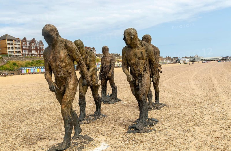 'Walking Men' artwork bronze sculptures by Laurence Edwards, South Beach, Lowestoft, Suffolk, England, UK July 2024